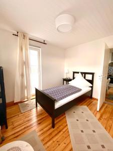 a bedroom with a bed and a large window at Ferienwohnung in Münchsmünster