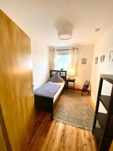 a bedroom with a bed and a window and a door at Ferienwohnung in Münchsmünster