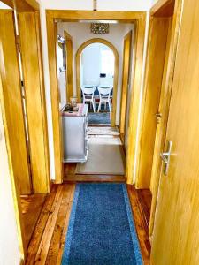 a hallway of a house with a kitchen and a table at Ferienwohnung in Münchsmünster +2 photos