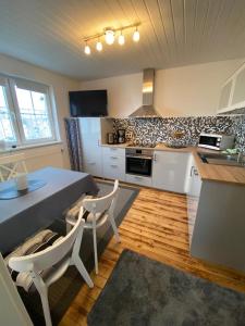 a kitchen with a table and chairs in a kitchen at Ferienwohnung in Münchsmünster