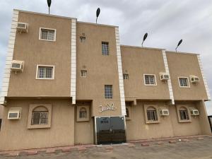 a large building with the front of it at Economic Homes Apartments in Yanbu
