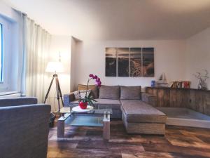 a living room with a couch and a table at Reet Landhaus Rügen in Ummanz