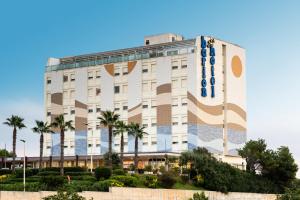 a building with a mural on the side of it at Barion Hotel & Congressi in Bari