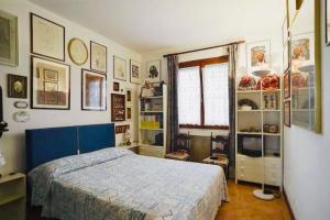 a bedroom with a bed and some pictures on the wall at Appartamento dei Salici in Lazise