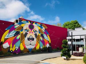 a mural of a lion on the side of a building at Mercure Reims Parc Des Expositions in Reims +75 photos