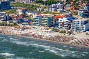 an aerial view of a beach with people and umbrellas at VELVET RESIDENCE in Mamaia Sat/Năvodari