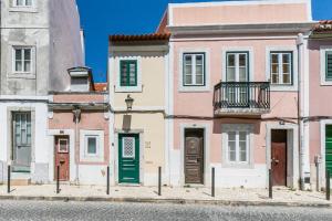 a row of houses on a street at Belem Skinny House in Lisbon