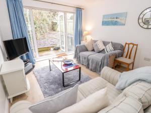 a living room with a couch and a table at 10 The Orchard in Colwyn Bay