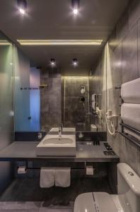 a bathroom with a sink and a toilet at Дизайн-готель ROAD in Kyiv