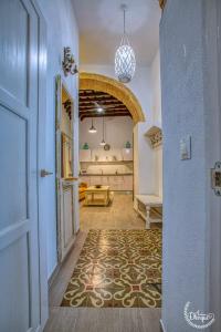a hallway with a door and a room with a table at CASA ARCO DEL CAÑÓN - Casita con Encanto in Medina Sidonia