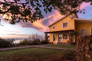 a house with the sunset in the background at Aelia & Melitta Villas in Perdhika