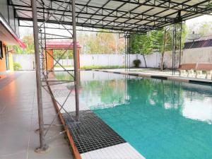 an empty swimming pool with a metal roof at Phurafa Resort in Phang-nga