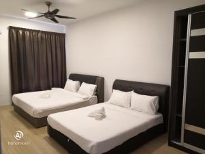 a bedroom with two beds and a ceiling fan at USJ One Premium Suites @Subang @Sunway @USJ in Subang Jaya