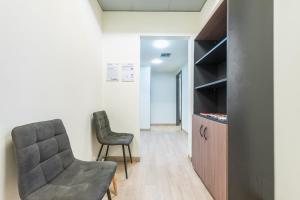 a living room with a chair and a cabinet at Athens Welcome Suites Apartments in Athens