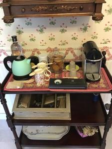 a table with a tea pot and other items on it at la VILLA B Chantilly in Orry-la-Ville