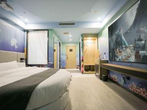 una camera con un grande letto e un dipinto sul muro di Thank Inn Plus Hotel Shandong Qingdao Licang Wan Nianquan Road a Qingdao