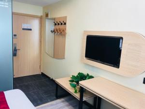 a room with a flat screen tv on a wall at Thank Inn Chain Hotel hebei baoding qingyuan district vocational education center in Baoding
