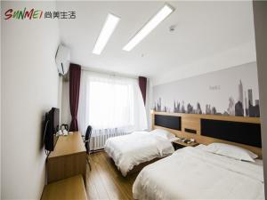 a hotel room with two beds and a window at Thank Inn Chain Hotel shandong yantai zhifu district RT-Mart railway station in Yantai