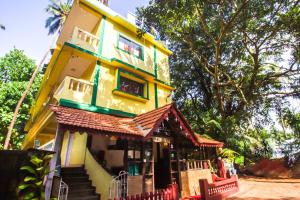 a yellow building with stairs up to it at Rustic Village - By Rivasa in Calangute