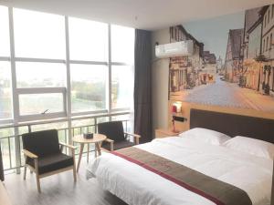a hotel room with a bed and a large window at Thank Inn Chain Hotel hebei handan wei county tian'an avenue chinese medicine hospital in Handan