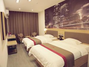 a hotel room with two beds and a large wall at Thank Inn Chain Hotel Jiangsu Suzhou Taihu Lake Dongshan Town in Suzhou