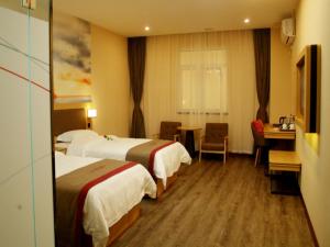 a hotel room with two beds and a desk at Thank Inn Chain Hotel anhui huinan shou county rose residence in Huainan