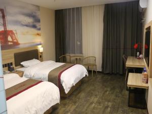 En eller flere senger på et rom på Thank Inn Chain Hotel jiangsu taizhou hailing district yingchun road