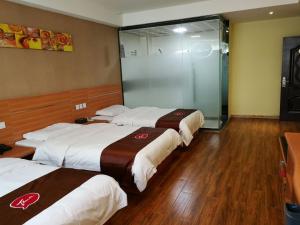 a group of three beds in a hotel room at Thank Inn Chain Hotel guizhou anshun huangguoshu scenic area in Anshun