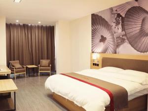 a hotel room with a large bed and chairs at Thank Inn Chain Hotel Jiangsu Suzhou Taihu Lake Dongshan Town in Suzhou