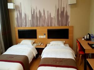 a hotel room with two beds and a desk at Thank Inn Chain Hotel Shanxi xianyang train station in Xianyang