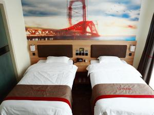 two beds in a room with a view of a bridge at Thank Inn Chain Hotel Jiangsu nantong tongzhou district XianFeng Town KaiHao square in Nantong