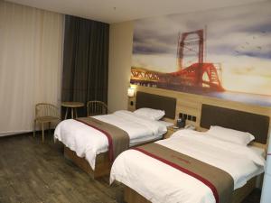 a hotel room with two beds and a painting of a bridge at Thank Inn Chain Hotel jiangsu taizhou hailing district yingchun road in Taizhou