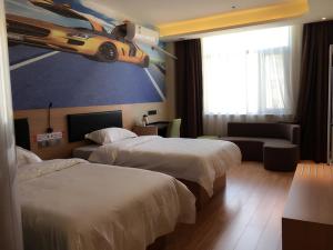 a hotel room with two beds and a car on the wall at Thank Inn Chain Hotel henan kaifeng lankao county chengguan town government in Kaifeng