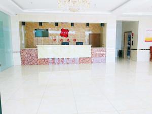 a lobby with a counter in the middle of a building at Thank Inn Chain Hotel hebei zhangjiakou wanquan county kongjiazhuang bus station in Zhangjiakou
