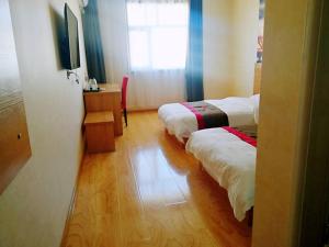 Cette chambre comprend 2 lits et une fenêtre. dans l'établissement Thank Inn Chain Hotel hebei zhangjiakou wanquan county kongjiazhuang bus station, à Zhangjiakou