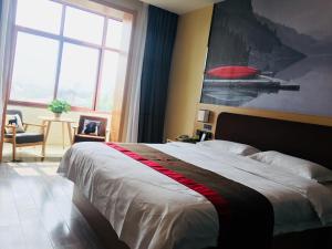 a bedroom with a large bed and a large window at Thank Inn Chain Hotel hebei baoding qingyuan district vocational education center in Baoding