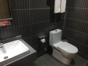 a bathroom with a white toilet and a sink at Thank Inn Chain Hotel sichuan guang'an yuechi rongxinyue city in Guang'an