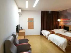 a hotel room with two beds and a television at Thank Inn Chain Hotel Jiangsu suzhou kunshan foxconn in Suzhou +7 photos