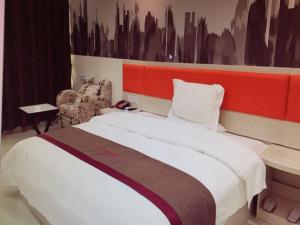 a bedroom with a large bed with a red headboard at Thank Inn Chain Hotel jiangxi fuzhou linchuan district new no.3 middle school in Fuzhou