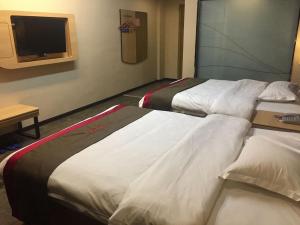a hotel room with two beds and a tv at Thank Inn Chain Hotel guangxi liuzhou luzhai county square in Liuzhou