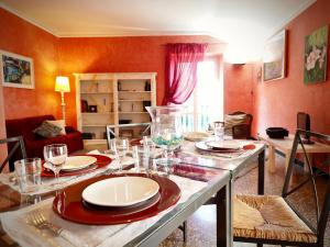 a dining room with a table with plates and wine glasses at DIMORA LUCCOLI ACQUARIO - GENOVABNB it in Genova +26 photos
