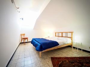 a bedroom with a bed and a chair in a room at DIMORA LUCCOLI ACQUARIO - GENOVABNB it in Genova
