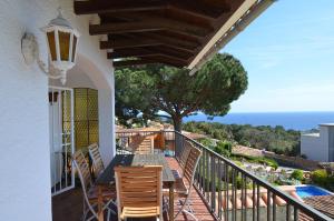 balcón con mesa, sillas y vistas al océano en Club Villamar - Pitagoras, en Lloret de Mar