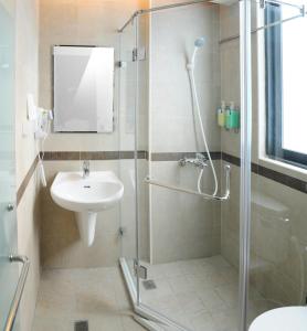 a bathroom with a shower and a sink at Garden Hotel in Taichung