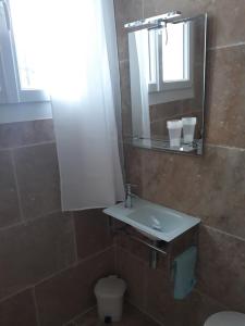 a bathroom with a sink and a mirror and a toilet at l'ecrin bleu in Les Issambres