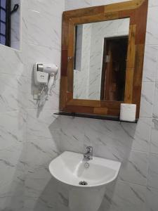 a bathroom with a sink and a mirror at Alona Vikings Lodge 1 in Panglao Island
