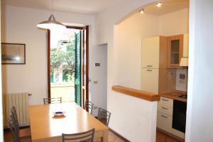 a kitchen and dining room with a wooden table at La Torre in Marciana Marina