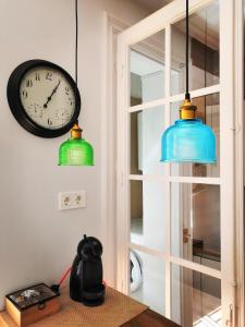 two clocks hanging on a wall next to a table at La Parada in Zaragoza