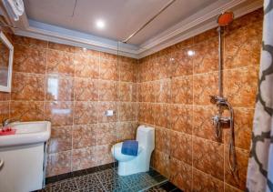 a bathroom with a toilet and a shower at Akvavit Living in Jomtien Beach