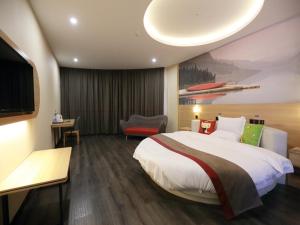 a hotel room with a large bed and a television at Thank Inn Chain Hotel Xiangyang east railway station in hubei province in Xiangyang